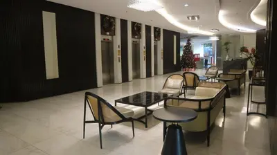 a lobby with chairs and tables and a christmas tree at 2BR Condo w Pool Loft at Fort Victoria BGC Taguig in Manila