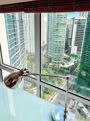 a glass window with a view of a city at 2BR Condo w Pool Loft at Fort Victoria BGC Taguig in Manila