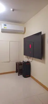 a room with a flat screen tv on a wall at 1Bedroom2603A Sunshine100Tower3 70Inches TV Pool Karaoke in Manila