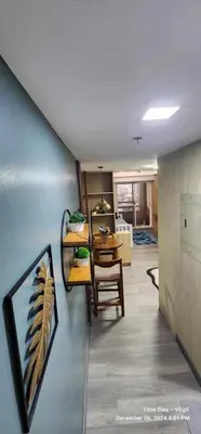 a living room with a table and a dining room at Propitious Place at Sta Mesa in Manila