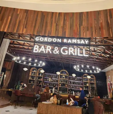 a bar and grill with people sitting at the counter at Gallardo Condo Stays at Eighty One Newport Boulevard Newport City, Pasay City near NAIA Terminal 3 in Manila