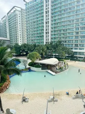 a large swimming pool in front of tall buildings at SM Bicutan Getaway in Manila