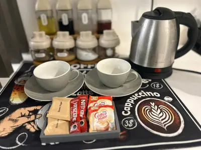 a tray with cups of coffee and snacks on a counter at SM Bicutan Getaway in Manila