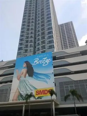 a large building with a sign on the side of it at Rhoydez Condotel Breeze Residence in Manila