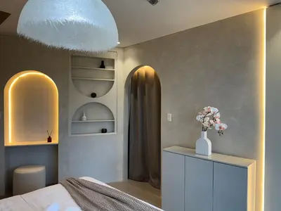 a bedroom with a bed and a vase of flowers on a cabinet at Panoramic Landscape Seaview, 2BR, near Airport, 11m in Manila