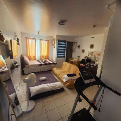 a small room with a bed and a treadmill at DJ's Staycation in Santa Rosa