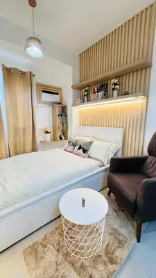 a bedroom with a white bed and a couch at Student Hub at DLSU in Pasong Bayog