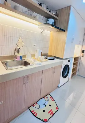 a kitchen with a sink and a washing machine at Student Hub at DLSU in Pasong Bayog