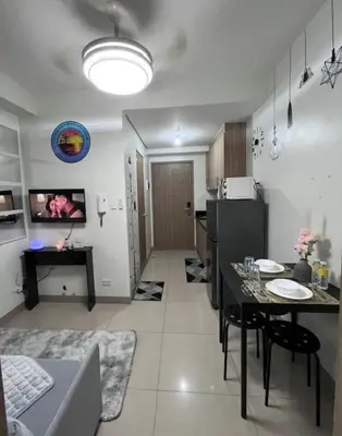 a kitchen with a table and a dining room at The Jenz Spot Shore Staycation in Manila