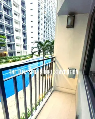 a balcony of a building with a swimming pool at The Jenz Spot Shore Staycation in Manila