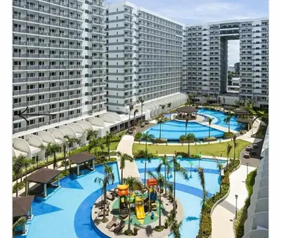 an aerial view of a resort with two pools at Shell Residences Family Suites 2 in Manila