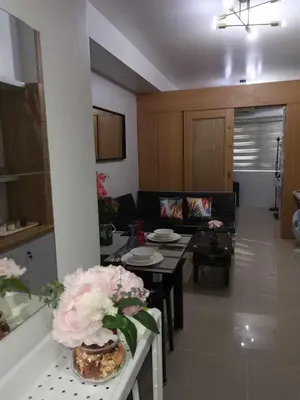 a living room with a couch and a table at Shell Residences Family Suites 2 in Manila