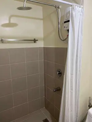 a shower with a shower curtain in a bathroom at Modern Studio Condominium 2 in Manila