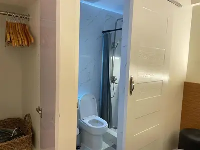 a bathroom with a toilet and a shower at Pinecrest residential resort in Manila
