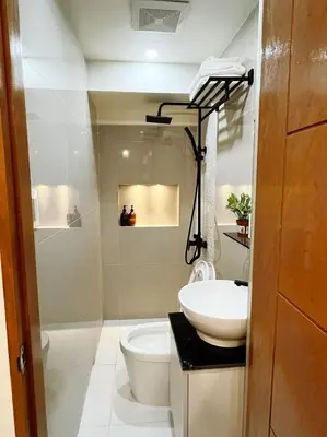 a bathroom with a white sink and a toilet at C&G Staycation Home in General Trias