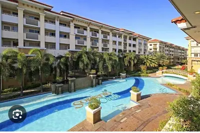 a large swimming pool in front of a building at Escapade Home in Manila