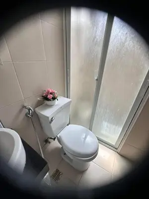 a bathroom with a toilet with a flower on it at Phebs 2bedroom with pool view in the heart of Makati in Manila