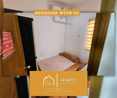 a room with a bedroom with a bed and a door at Arah Cozy House in Dasmariñas