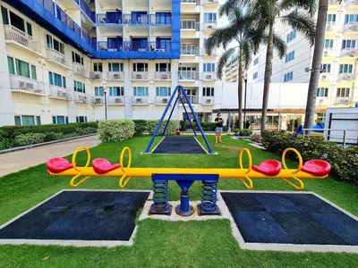 a playground in a park in front of a building at Sea Residences - MOA in Manila
