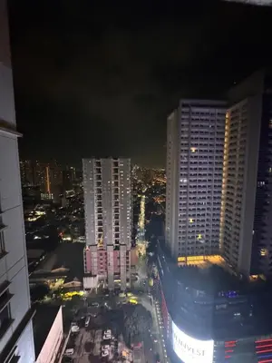 a view of a city at night with tall buildings at Urban Oasis Studio at Central District Makati in Manila