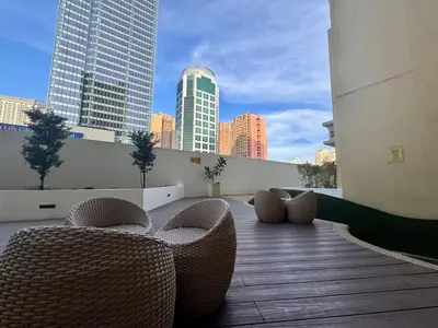a balcony with chairs and a view of the city at Urban Oasis Studio at Central District Makati in Manila