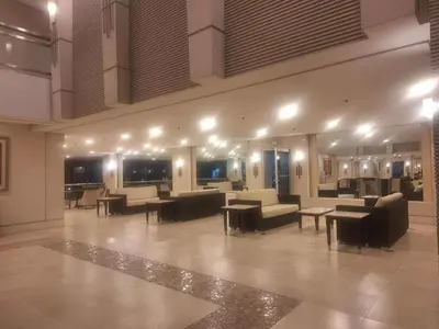 a lobby with couches and tables in a building at Field Residences by Diane in Manila