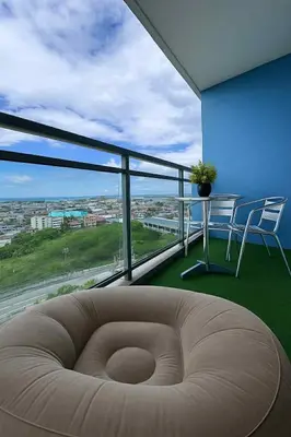 a living room with a couch and a table and chairs at Golden Hour Escape in Manila