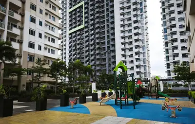 a playground in a apartment complex with playground equipment at Modern Studio Condo in Heart of Quezon City in Manila