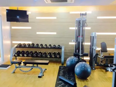 a gym with dumbbells and weights in a room at Airport View Walk to NAIA 3 in Manila