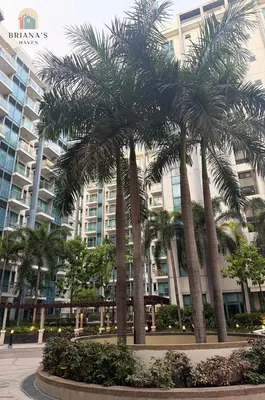 a group of palm trees in front of a building at Airport View Walk to NAIA 3 in Manila