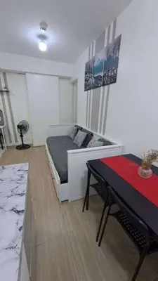 a bedroom with a bed and a table in it at AZURE BICUTAN BACKPACKERS MAUI Tower in Manila
