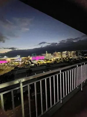 a view of a city at night from a balcony at 1148a 3br 1-king size 1queen size 2 double size 2-single size 1-extra matress Moa view in Manila