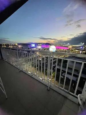 a balcony with a view of a city at night at 1148a 3br 1-king size 1queen size 2 double size 2-single size 1-extra matress Moa view in Manila