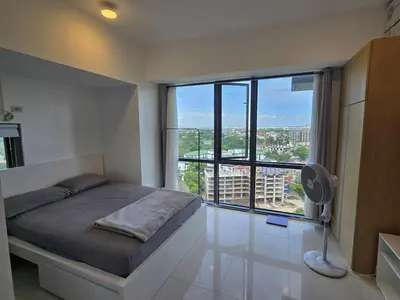 a bedroom with a bed and a large window at Cozy Corner Studio in McKinley Walk to Venice Mall in Manila