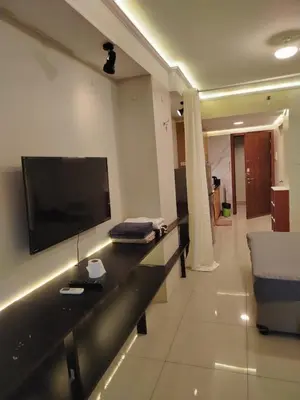 a living room with a flat screen tv on a wall at Shell Residences MOA 2 beds by Dad's in Manila