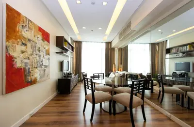 a dining room and living room with a table and chairs at Elegant 2BR Apartment in Upscale Fort BGC Fast Wifi in Manila