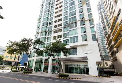 a tall building on a city street with a building at Elegant 2BR Apartment in Upscale Fort BGC Fast Wifi in Manila