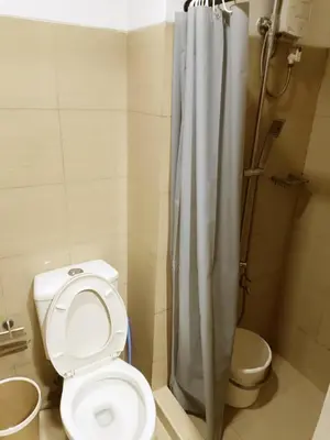 a bathroom with a toilet and a shower at Spacious 1BR beside MOA with Wifi, Netflix, Pool & Washer in Manila