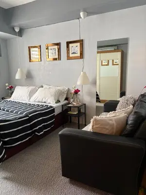 a bedroom with a bed and a couch at Amaia skies cubao in Manila