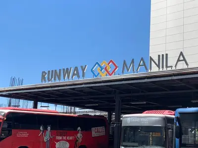 a sign for a railway manilla with buses parked under it at Your Home at One Palm Tree Villas near NAIA T3 in Manila