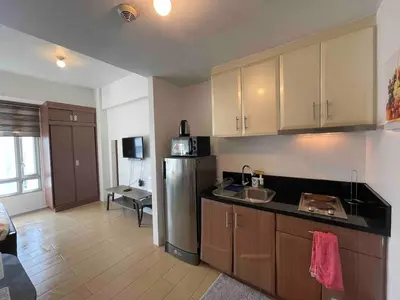 a kitchen with a sink and a refrigerator at Tiny home near NAIA Terminal 3 in Manila