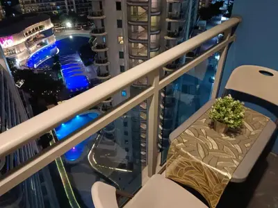 a table on a balcony with a view of a city at 1BR Condotel in Azure Urban Resort Near NAIA #BH1 in Manila