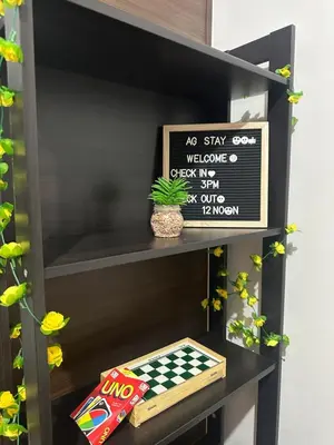 a black shelf with a chess board and a sign at Air Residences staycation2 in Manila
