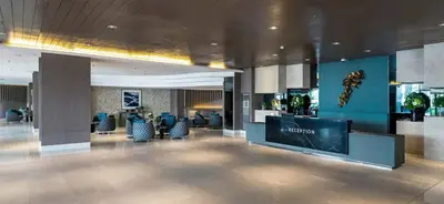 a lobby of a hotel with a reception desk and chairs at Shore Stay in Manila