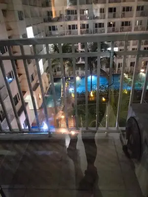 a view from the balcony of a building at night at Ellein's Condotel in Manila