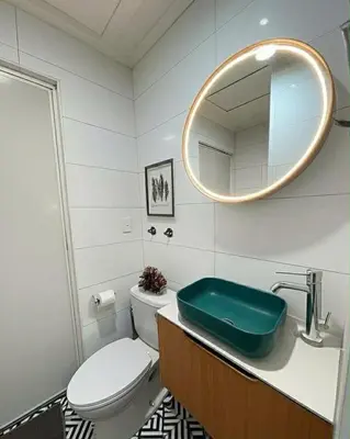 a bathroom with a toilet and a sink with a mirror at Close by the airports and tourist attractions in Manila