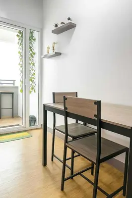 a dining room with a bench and a table at Close by the airports and tourist attractions in Manila