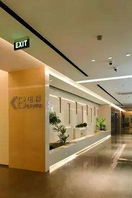 an exit sign in a building with potted plants at Happy Holiday in Manila