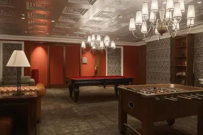 a living room with a pool table and a table sidx sidx sidx at The Spot 43 Sunrise in Makati in Manila