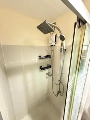 a shower with a shower head in a bathroom at R&K Staycation in Manila